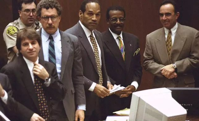 FILE - Defendant O.J. Simpson and members of his defense team react as the jury, many wearing white T-shirts sporting a slogan from a local pizza chain, walk into the courtroom in Los Angeles Friday, May 5, 1995. From left to right are" Barry Scheck, Peter Neufeld, O.J. Simpson, Johnnie Cochran Jr., and Robert Shapiro. Background is Deputy Guy Magnera. Simpson, the decorated football superstar and Hollywood actor who was acquitted of charges he killed his former wife and her friend but later found liable in a separate civil trial, has died. He was 76. (AP Photo/Reed Saxon, Pool, File)