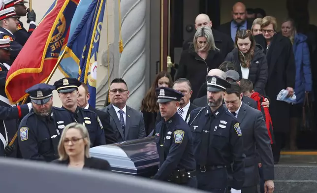 FILE - Boston police officers carry the casket of officer John O'Keefe from St. Francis of Assisi Church, Feb. 7, 2022, in Braintree. Mass. O'Keefe was found dead outside the home of a fellow officer in January 2022, and his girlfriend, Karen Read, has been charged with his death. Read's trial is scheduled to begin Monday, April 29, 2024. (David L. Ryan//The Boston Globe via AP, File)