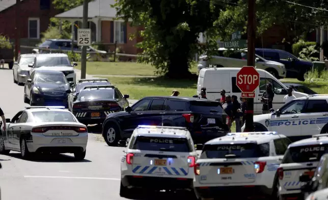 Multiple law enforcement vehicles respond in the neighborhood where several officers on a task force trying to serve a warrant were shot in Charlotte, N.C., Monday, April 29, 2024. (Khadejeh Nikouyeh/The Charlotte Observer via AP)