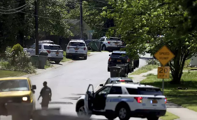 Police work at the scene of a shooting Monday, April 29, 2024, in east Charlotte, N.C. Officers from the U.S. Marshals Task Force were conducting an investigation in a suburban neighborhood when they were fired upon, the CMPD said in a post on X. (Khadejeh Nikouyeh/The Charlotte Observer via AP)