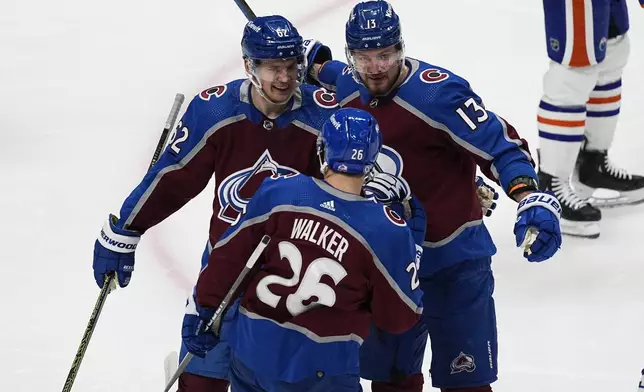 Colorado Avalanche right wing Valeri Nichushkin, back right, is congratulated by left wing Artturi Lehkonen, back left, and defenseman Sean Walker for a goal against the Edmonton Oilers during the first period of an NHL hockey game Thursday, April 18, 2024, in Denver. (AP Photo/David Zalubowski)