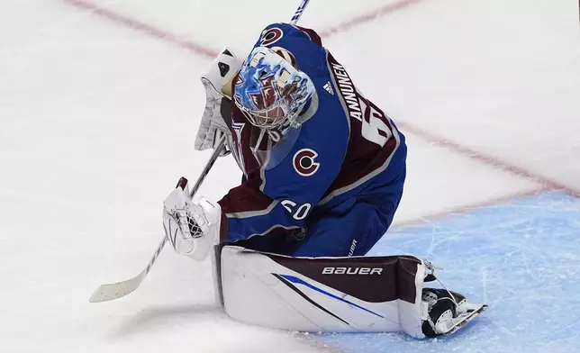 Colorado Avalanche goaltender Justus Annunen makes a glove save during the third period of the team's NHL hockey game against the Edmonton Oilers on Thursday, April 18, 2024, in Denver. (AP Photo/David Zalubowski)