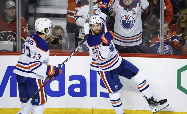 Edmonton Oilers forward Connor Brown (28) celebrates his goal against the Calgary Flames with forward Mattias Janmark (13) during the second period of an NHL hockey game Saturday, April 6, 2024, in Calgary, Alberta. (Jeff McIntosh/The Canadian Press via AP)