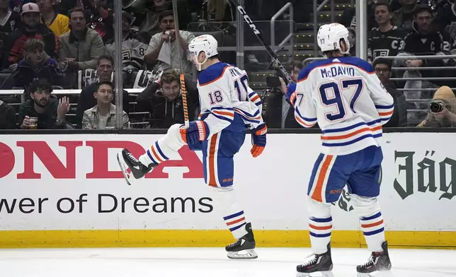 Edmonton Oilers left wing Zach Hyman, left, celebrates his goal as center Connor McDavid follows during Game 3 of an NHL hockey Stanley Cup first-round playoff series against the Los Angeles Kings Friday, April 26, 2024, in Los Angeles. (AP Photo/Mark J. Terrill)