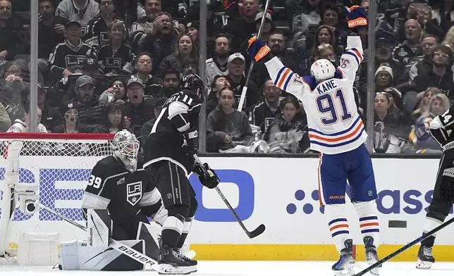 Edmonton Oilers left wing Evander Kane, right, celebrates his goal as Los Angeles Kings goaltender Cam Talbot, left, and center Anze Kopitar look on during the second period in Game 3 of an NHL hockey Stanley Cup first-round playoff series Friday, April 26, 2024, in Los Angeles. (AP Photo/Mark J. Terrill)