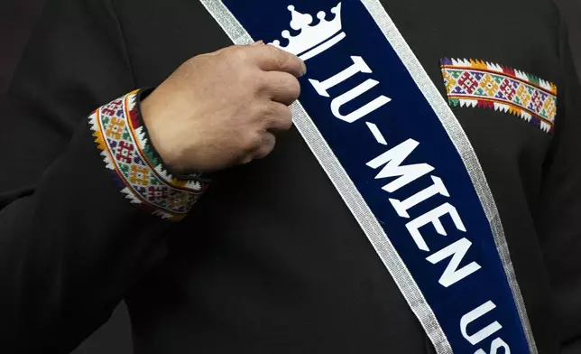 Cheng "Charlie" Saephan points to his sash that reads "Iu-Mien USA" while speaking during a news conference after it was revealed that he was one of the winners of the $1.3 billion Powerball jackpot at the Oregon Lottery headquarters, Monday, April 29, 2024, in Salem, Ore. (AP Photo/Jenny Kane)