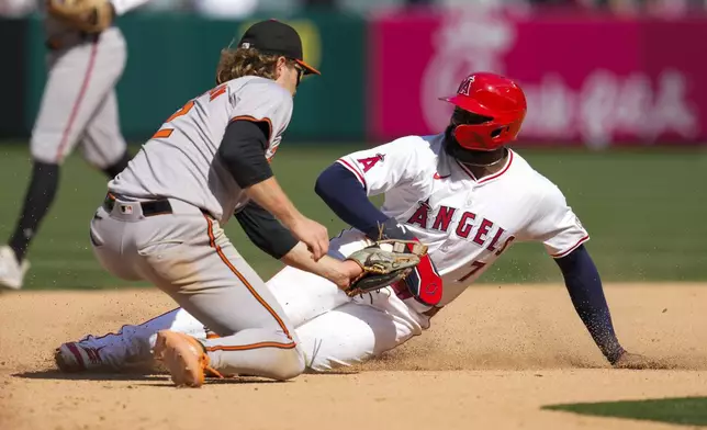 Los Angeles Angels' Jo Adell (7) is caught stealing second by Baltimore Orioles shortstop Gunnar Henderson (2) during the ninth inning of a baseball game in Anaheim, Calif., Wednesday, April 24, 2024. (AP Photo/Ashley Landis)