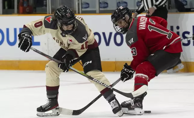 Montreal's Brigitte Laganiere, left, battles with Ottawa's Tereza Vanisova for control of the puck during the first period of a PWHL hockey game, Saturday, April 27, 2024 in Ottawa, Ontario. (Adrian Wyld/The Canadian Press via AP)
