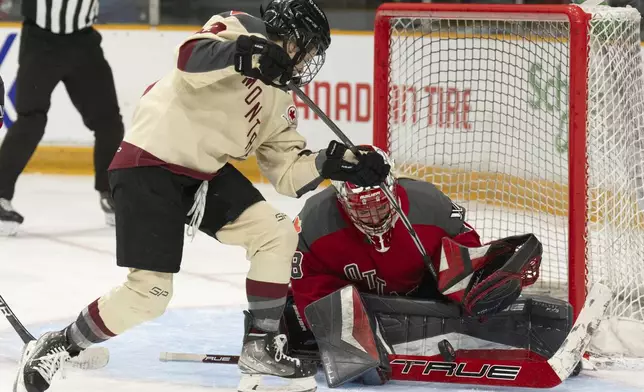 Montreal forward Kristin O'Neill tries to put the puck past Ottawa goalie Emerance Maschmeyer during the first period of a PWHL hockey game, Saturday, April 27, 2024 in Ottawa, Ontario. (Adrian Wyld/The Canadian Press via AP)