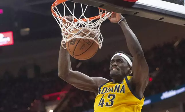 Indiana Pacers' Pascal Siakam dunks against the Cleveland Cavaliers during the second half of an NBA basketball game in Cleveland, Friday, April 12, 2024. (AP Photo/Phil Long)