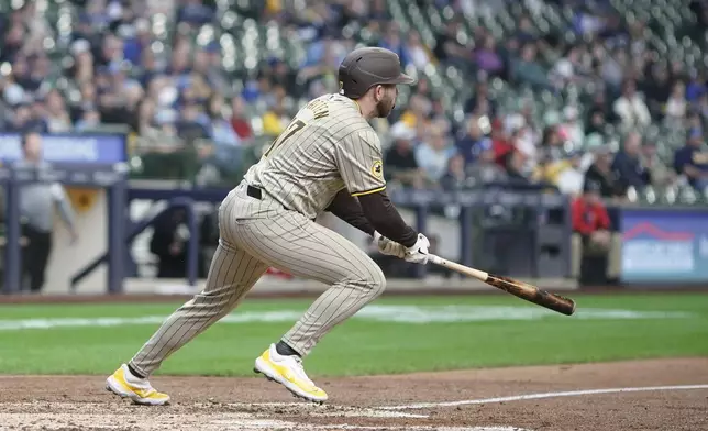 San Diego Padres' Matthew Batten hits a triple during the eighth inning of a baseball game against the Milwaukee Brewers Wednesday, April 17, 2024, in Milwaukee. (AP Photo/Morry Gash)