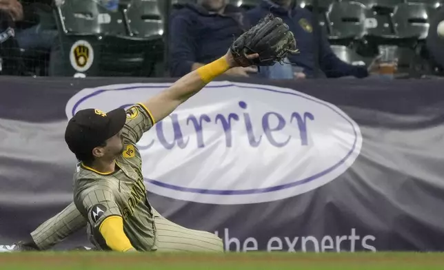 San Diego Padres' Tyler Wade can't catch a foul ball hit by Milwaukee Brewers' Brice Turang during the eighth inning of a baseball game Wednesday, April 17, 2024, in Milwaukee. (AP Photo/Morry Gash)