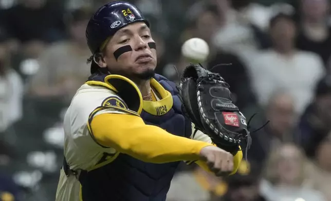 Milwaukee Brewers catcher William Contreras makes a play on a bunt by San Diego Padres' Tyler Wade during the second inning of a baseball game Monday, April 15, 2024, in Milwaukee. (AP Photo/Morry Gash)