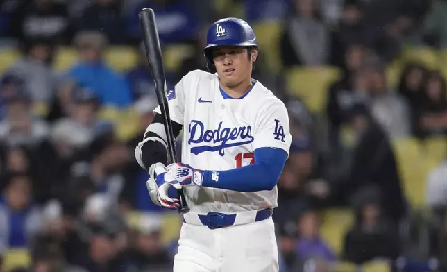 Los Angeles Dodgers' Shohei Ohtani walks up to bat during the first inning of the team's baseball game against the San Diego Padres, Saturday, April 13, 2024, in Los Angeles. (AP Photo/Marcio Jose Sanchez)