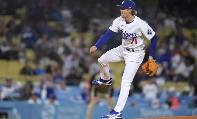 Los Angeles Dodgers starting pitcher Gavin Stone watches a throw to a San Diego Padres batter during the first inning of a baseball game Saturday, April 13, 2024, in Los Angeles. (AP Photo/Marcio Jose Sanchez)