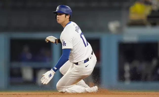 Los Angeles Dodgers' Shohei Ohtani steals second base against the San Diego Padres during the first inning of a baseball game Saturday, April 13, 2024, in Los Angeles. (AP Photo/Marcio Jose Sanchez)