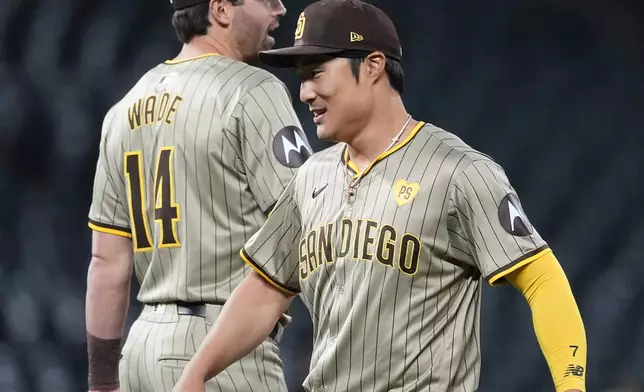 San Diego Padres shortstop Ha-Seong Kim, right, is congratulated by third baseman Tyler Wade, left, after a baseball game against the Colorado Rockies, Monday, April 22, 2024, in Denver. (AP Photo/David Zalubowski)
