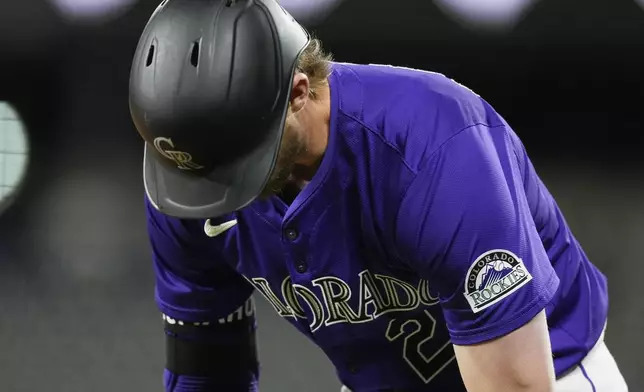 Colorado Rockies' Ryan McMahon reacts after grounding into a double play against San Diego Padres relief pitcher Robert Suarez to end the ninth inning of a baseball game Monday, April 22, 2024, in Denver. (AP Photo/David Zalubowski)
