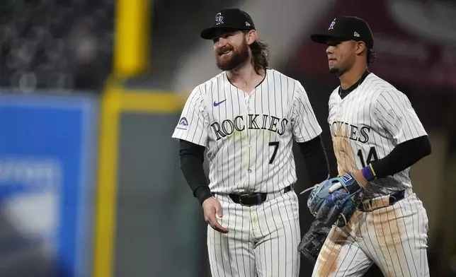 Colorado Rockies second baseman Brendan Rodgers, left, celebrates with shortstop Ezequiel Tovar after the team's baseball game against the San Diego Padres on Tuesday, April 23, 2024, in Denver. (AP Photo/David Zalubowski)