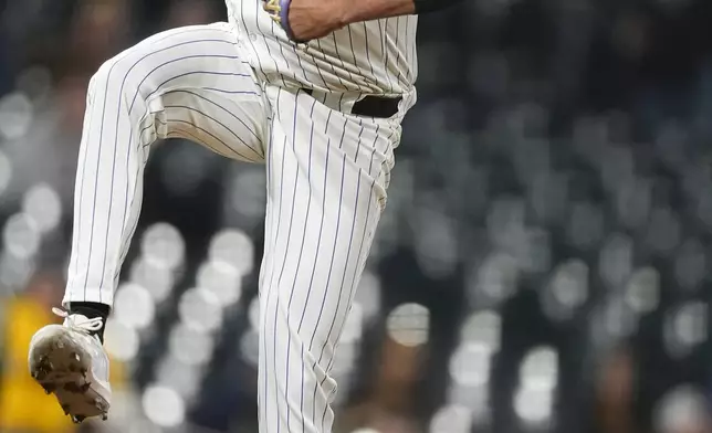 Colorado Rockies relief pitcher Justin Lawrence jumps after delivering a pitch to San Diego Padres' Jake Cronenworth during the ninth inning of a baseball game Tuesday, April 23, 2024, in Denver. (AP Photo/David Zalubowski)