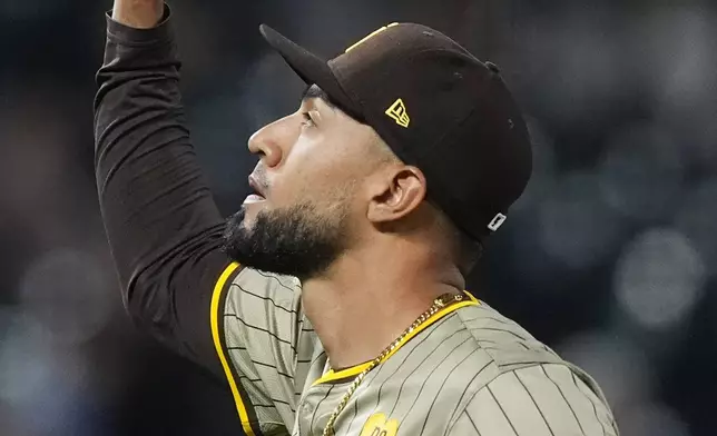 San Diego Padres relief pitcher Robert Suarez gestures after the Padres defeated the Colorado Rockies in a baseball game Wednesday, April 24, 2024, in Denver. (AP Photo/David Zalubowski)