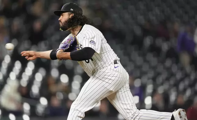 Colorado Rockies relief pitcher Justin Lawrence works against the San Diego Padres during the ninth inning of a baseball game Tuesday, April 23, 2024, in Denver. (AP Photo/David Zalubowski)
