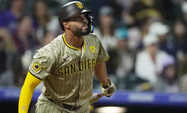 San Diego Padres' Xander Bogaerts singles against Colorado Rockies relief pitcher Anthony Molina in the seventh inning of a baseball game, Wednesday, April 24, 2024, in Denver. (AP Photo/David Zalubowski)