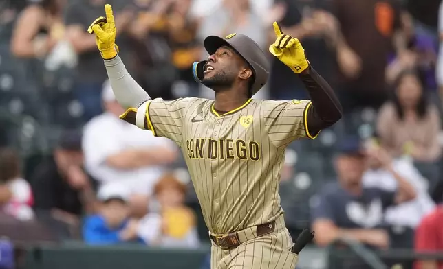 San Diego Padres' Jurickson Profar gestures as he circles the bases after hitting a two-run home run off Colorado Rockies relief pitcher Nick Mears in the seventh inning of a baseball game Thursday, April 25, 2024, in Denver. (AP Photo/David Zalubowski)