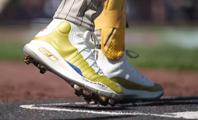 FILE - The cleats of San Diego Padres' Fernando Tatis Jr. are shown during the sixth inning of a baseball game against the San Francisco Giants in San Francisco, Friday, April 5, 2024. Tatis plans to unveil 50 pairs of custom cleats this season in conjunction with his branding company, Xample, and Los Angeles-based Shoe Surgeon. The cleats will honor people, events and whatever strikes the 25-year-old Tatis' fancy. (AP Photo/Eric Risberg, File)