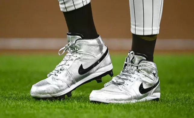 FILE - San Diego Padres' Fernando Tatis Jr. (23) wears silver Nike cleats during a baseball game against the St. Louis Cardinals, Monday, April 1, 2024, in San Diego. Tatis plans to unveil 50 pairs of custom cleats this season in conjunction with his branding company, Xample, and Los Angeles-based Shoe Surgeon. The cleats will honor people, events and whatever strikes the 25-year-old Tatis' fancy. (AP Photo/Denis Poroy, File)