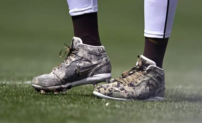 FILE - San Diego Padres outfielder Fernando Tatis Jr. wears cleats in honor of the U.S. military during the team's baseball game against the San Francisco Giants on March 31, 2024, in San Diego. Tatis Jr. plans to unveil 50 pairs of custom cleats this season.(AP Photo/Denis Poroy, File)