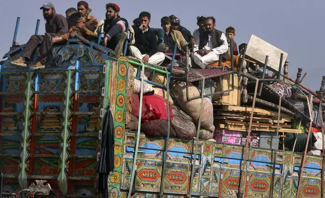 FILE - Afghan families onboard a truck head toward a border crossing point in Torkham, Pakistan, Tuesday, Oct. 31, 2023. For more than 1 million Afghans who fled war and poverty to Pakistan, these are uncertain times. Since Pakistan announced a crackdown on migrants last year, some 600,000 have been deported and at least a million remain in Pakistan in hiding. They've retreated from public view, abandoning their jobs and rarely leaving their neighborhoods out of fear they could be next. It's harder for them to earn money, rent accommodation, buy food or get medical help because they run the risk of getting caught by police or being reported to authorities by Pakistanis.(AP Photo/Muhammad Sajjad, File)