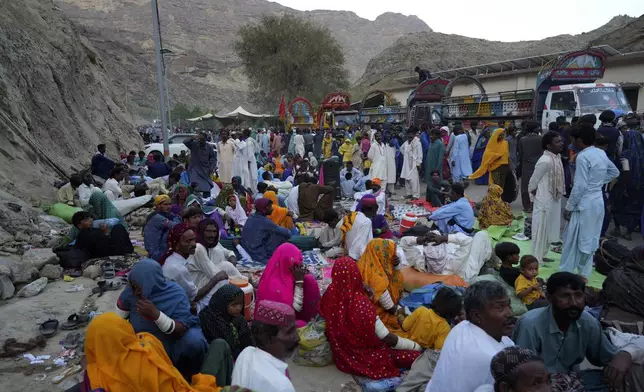 Hindu devotees take rest upon arrival at an ancient cave temple of Hinglaj Mata to attend an annual festival in Hinglaj in Lasbela district in the Pakistan's southwestern Baluchistan province, Friday, April 26, 2024. More than 100,000 Hindus are expected to climb mud volcanoes and steep rocks in southwestern Pakistan as part of a three-day pilgrimage to one of the faith's holiest sites. (AP Photo/Junaid Ahmed)