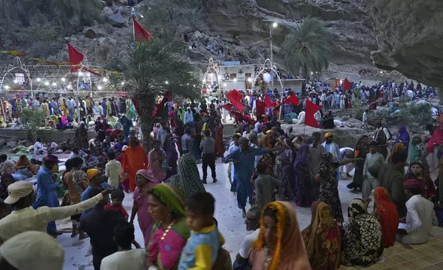 Hindu devotees arrive at an ancient cave temple of Hinglaj Mata to attend an annual festival in Hinglaj in Lasbela district in Pakistan's southwestern Baluchistan province, Friday, April 26, 2024. More than 100,000 Hindus are expected to climb mud volcanoes and steep rocks in southwestern Pakistan as part of a three-day pilgrimage to one of the faith's holiest sites. (AP Photo/Junaid Ahmed)