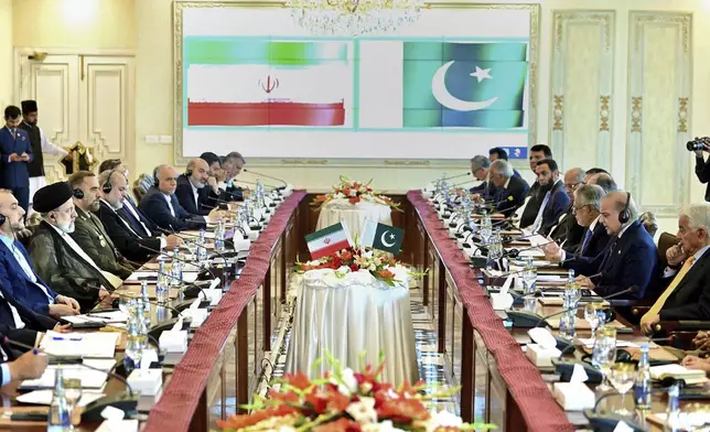 In this photo released by Press Information Department, Iranian President Ebrahim Raisi, second left, holds official talks with Pakistan's Prime Minister Shehbaz Sharif, second right, at prime minister house in Islamabad, Pakistan, Monday, April 22, 2024. Iranian and Pakistani leaders vowed to strengthen economic and security cooperation in a meeting on Monday, as the two countries seek to smooth over a diplomatic rift. (Press Information Department via AP)