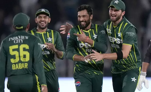 Pakistan's Mohammad Amir, second right, celebrates with teammates after taking the wicket of New Zealand's Tim Robinson during the second T20 international cricket match between Pakistan and New Zealand, in Rawalpindi, Pakistan, Saturday, April 20, 2024. (AP Photo/Anjum Naveed)