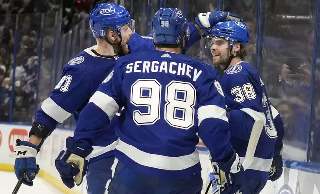 Tampa Bay Lightning left wing Brandon Hagel (38) celebrates his goal against the Florida Panthers with defenseman Erik Cernak (81) and defenseman Mikhail Sergachev (98) during the second period in Game 4 of an NHL hockey Stanley Cup first-round playoff series, Saturday, April 27, 2024, in Tampa, Fla. (AP Photo/Chris O'Meara)
