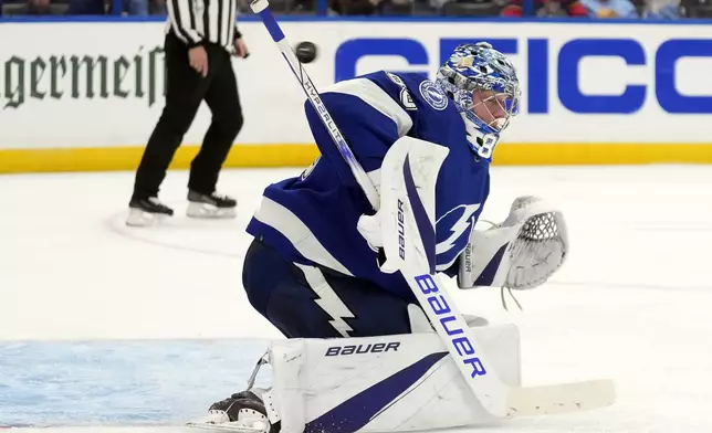 Tampa Bay Lightning goaltender Andrei Vasilevskiy (88) makes a stick save on a shot by the Florida Panthers during the third period in Game 4 of an NHL hockey Stanley Cup first-round playoff series, Saturday, April 27, 2024, in Tampa, Fla. (AP Photo/Chris O'Meara)