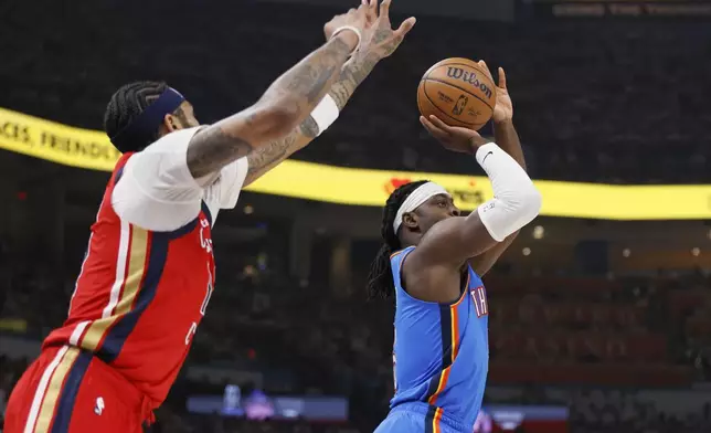 Oklahoma City Thunder guard Luguentz Dort, right, prepares to shoot next to New Orleans Pelicans forward Brandon Ingram during the first half in Game 2 of an NBA basketball first-round playoff series Wednesday, April 24, 2024, in Oklahoma City. (AP Photo/Nate Billings)