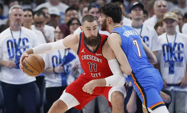 New Orleans Pelicans center Jonas Valanciunas (17) is defended by Oklahoma City Thunder forward Chet Holmgren (7) during the first half in Game 2 of an NBA basketball first-round playoff series Wednesday, April 24, 2024, in Oklahoma City. (AP Photo/Nate Billings)