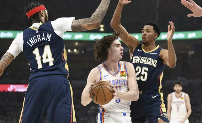 Oklahoma City Thunder guard Josh Giddey, middle, tries to pass around New Orleans Pelicans forward Brandon Ingram (14) and guard Trey Murphy III (25) in the first half of Game 1 of an NBA basketball first-round playoff series, Sunday, April 21, 2024, in Oklahoma City. (AP Photo/Kyle Phillips)