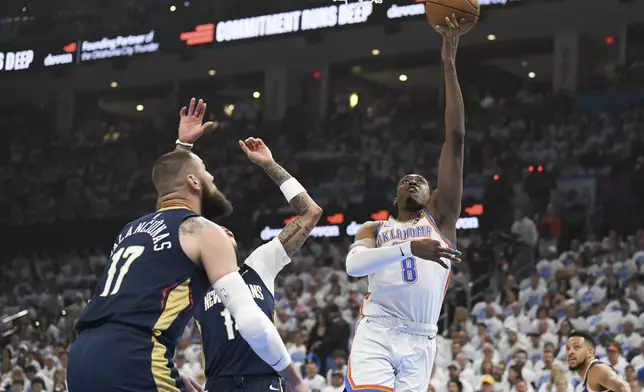Oklahoma City Thunder forward Jalen Williams (8) shoots around New Orleans Pelicans center Jonas Valanciunas (17) and forward Brandon Ingram, middle, in the first half of Game 1 of an NBA basketball first-round playoff series, Sunday, April 21, 2024, in Oklahoma City. (AP Photo/Kyle Phillips)