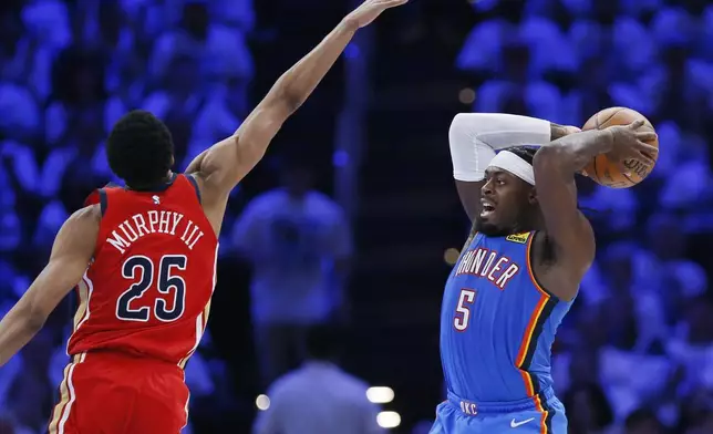 Oklahoma City Thunder guard Luguentz Dort (5) looks to pass the ball away from New Orleans Pelicans guard Trey Murphy III (25) during the second half in Game 2 of an NBA basketball first-round playoff series Wednesday, April 24, 2024, in Oklahoma City. (AP Photo/Nate Billings)