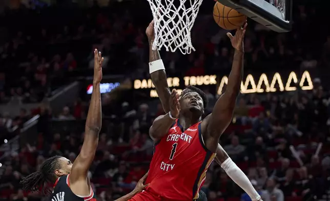 New Orleans Pelicans forward Zion Williamson (1) shoots over Portland Trail Blazers forward Jabari Walker during the second half of an NBA basketball game in Portland, Ore., Tuesday, April 9, 2024. (AP Photo/Craig Mitchelldyer)