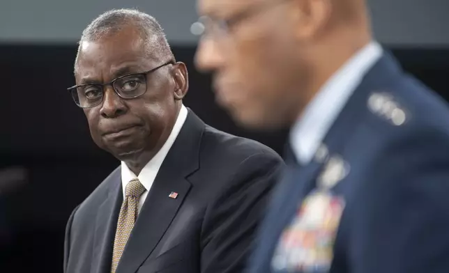 Defense Secretary Lloyd Austin, left, looks towards Chairman of the Joint Chiefs of Staff Gen. Charles Q. Brown Jr. during a press briefing on Friday, April 26, 2024 at the Pentagon in Washington. (AP Photo/Kevin Wolf)