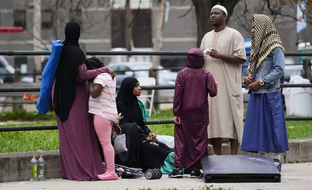 People gather in the aftermath of a shooting at an Eid al-Fitr event in Philadelphia, Wednesday, April 10, 2024. (AP Photo/Matt Rourke)