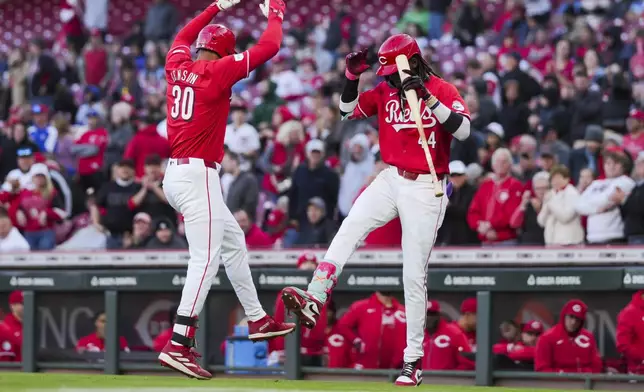 Cincinnati Reds' Will Benson, left, celebrates with Elly De La Cruz after hitting a solo home run against the Philadelphia Phillies during the third inning of a baseball game in Cincinnati, Wednesday, April 24, 2024. (AP Photo/Aaron Doster)