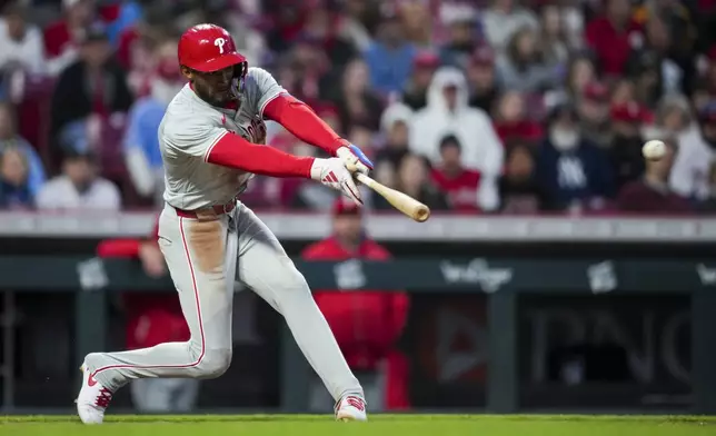 Philadelphia Phillies' Johan Rojas hits an RBI single during the sixth inning of the team's baseball game against the Cincinnati Reds in Cincinnati, Wednesday, April 24, 2024. (AP Photo/Aaron Doster)