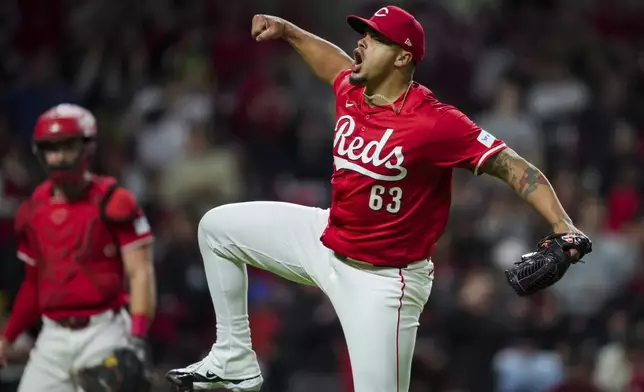 Cincinnati Reds' Fernando Cruz celebrates as he walks to the dugout after the final out in the top of the seventh inning of the team's baseball game against the Philadelphia Phillies in Cincinnati, Wednesday, April 24, 2024. (AP Photo/Aaron Doster)