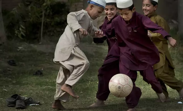 FILE - Boys play soccer during a break at their school in Kandahar, southern Afghanistan, Tuesday, Oct 29, 2013. (AP Photo/Anja Niedringhaus, File)